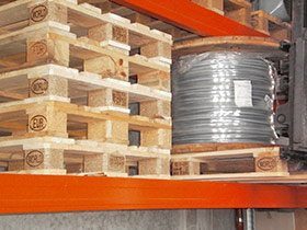 Euro pallet with a cable drum on a rack